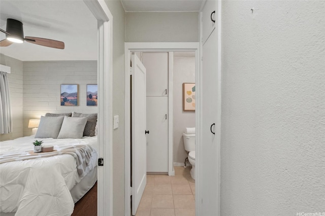 75 Kihapai St Unit 10, Kailua, HI 96734 - bedroom with baseboards, a ceiling fan, and light tile patterned floors