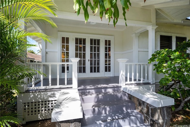 exterior space featuring covered porch and french doors