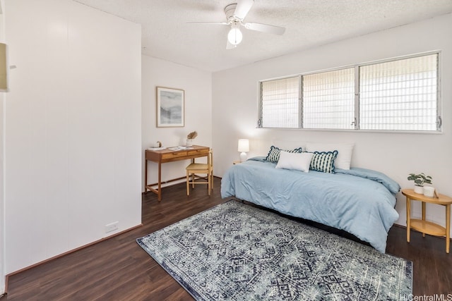 6215 Kawaihae Pl Unit B102, Honolulu, HI 96825 - bedroom featuring dark wood-type flooring, a textured ceiling, baseboards, and ceiling fan
