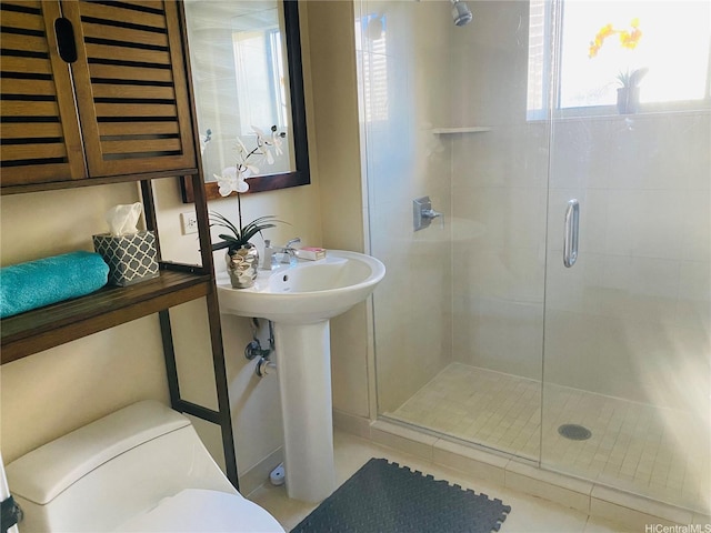bathroom featuring toilet and a stall shower