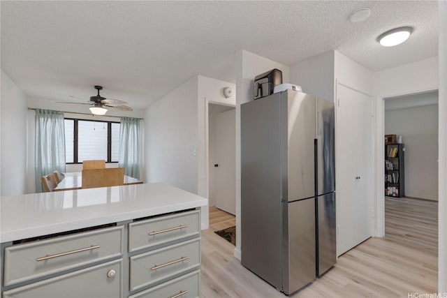 98-512 Kaonohi St Unit 49-3, Aiea, HI 96701 - kitchen featuring ceiling fan, light wood-style floors, light countertops, freestanding refrigerator, and gray cabinetry