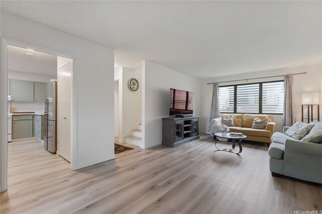 98-512 Kaonohi St Unit 49-3, Aiea, HI 96701 - living area with light wood-style floors, baseboards, and stairway