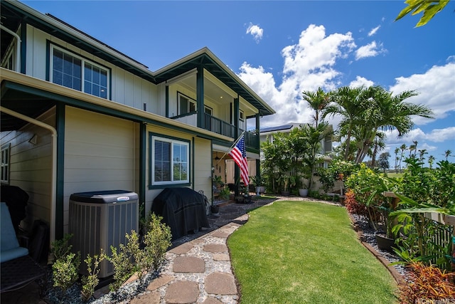 91-1243 Kuanoo St, Ewa Beach, HI 96706 - view of green lawn featuring cooling unit and a balcony