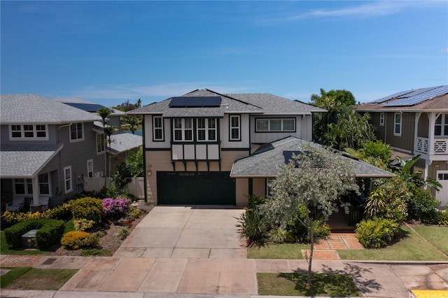 91-1243 Kuanoo St, Ewa Beach, HI 96706 - view of front of home featuring a shingled roof, concrete driveway, an attached garage, solar panels, and a residential view