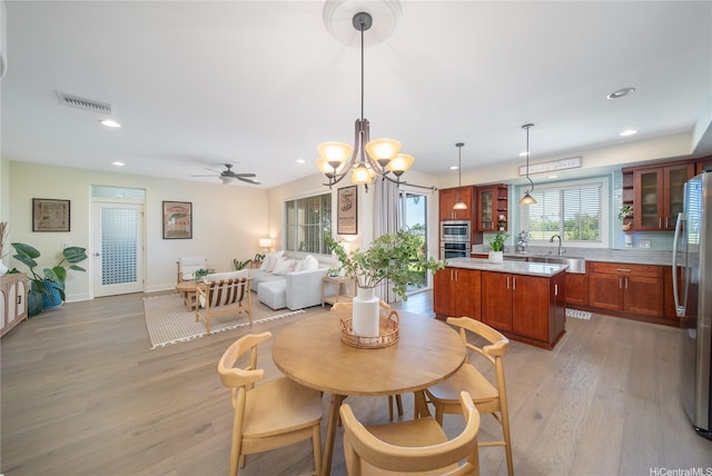 91-1243 Kuanoo St, Ewa Beach, HI 96706 - dining space featuring light wood-type flooring, recessed lighting, a chandelier, baseboards, and ceiling fan