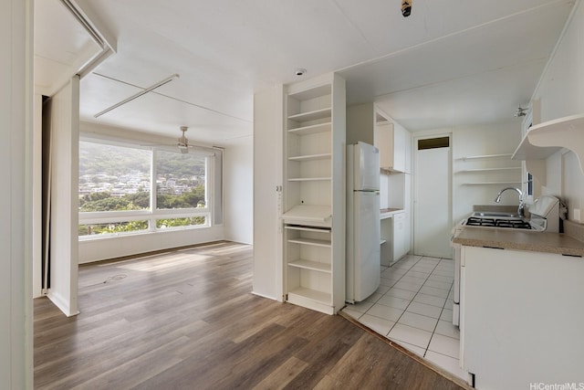 2519 Lai Rd Unit C, Honolulu, HI 96816 - kitchen featuring open shelves, freestanding refrigerator, white cabinetry, and light wood-type flooring