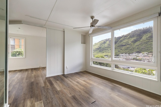 2519 Lai Rd Unit C, Honolulu, HI 96816 - empty room featuring plenty of natural light, wood finished floors, a mountain view, and a ceiling fan