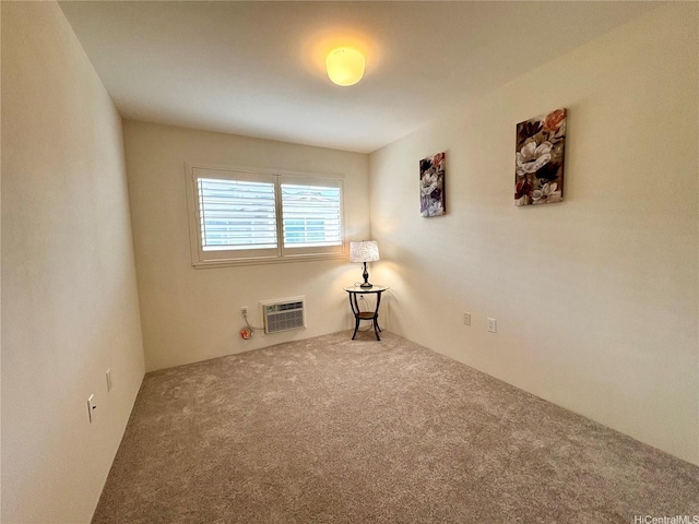 carpeted spare room with a wall unit AC