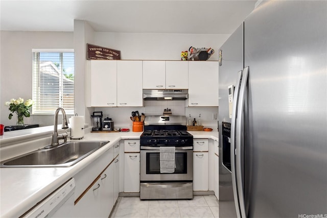 kitchen with white cabinets, a sink, light countertops, stainless steel appliances, and under cabinet range hood