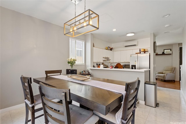 dining area with an AC wall unit, recessed lighting, baseboards, and a chandelier