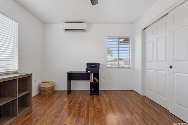 interior space featuring a wall mounted AC and wood finished floors