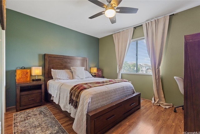 bedroom with baseboards, ceiling fan, and wood finished floors