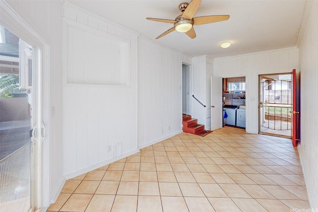 spare room with separate washer and dryer, ceiling fan, stairs, and a wealth of natural light
