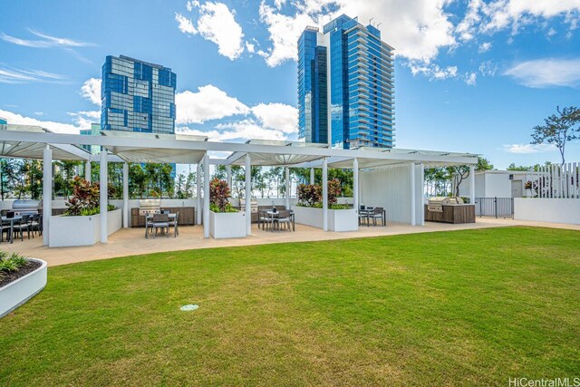 1000 Auahi St Unit 1404, Honolulu, HI 96814 - rear view of house featuring a yard, a pergola, outdoor dining space, and a patio area