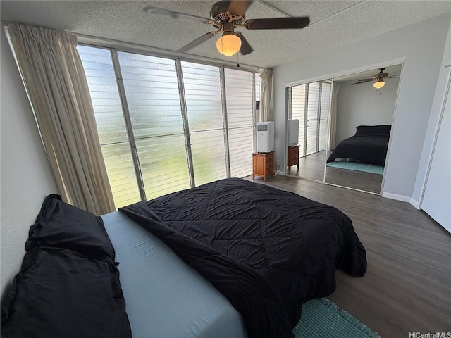 95-020 Waihonu St Unit C402, Mililani, HI 96789 - bedroom featuring a textured ceiling, baseboards, a ceiling fan, and wood finished floors
