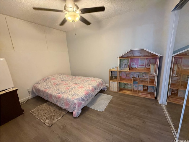 95-020 Waihonu St Unit C402, Mililani, HI 96789 - bedroom featuring a textured ceiling, ceiling fan, and wood finished floors