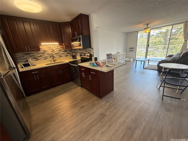 95-020 Waihonu St Unit C402, Mililani, HI 96789 - kitchen featuring open floor plan, a sink, a textured ceiling, and stainless steel appliances