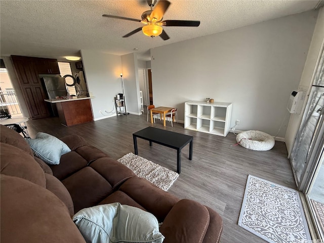 95-020 Waihonu St Unit C402, Mililani, HI 96789 - living room with baseboards, a ceiling fan, dark wood-style flooring, and a textured ceiling