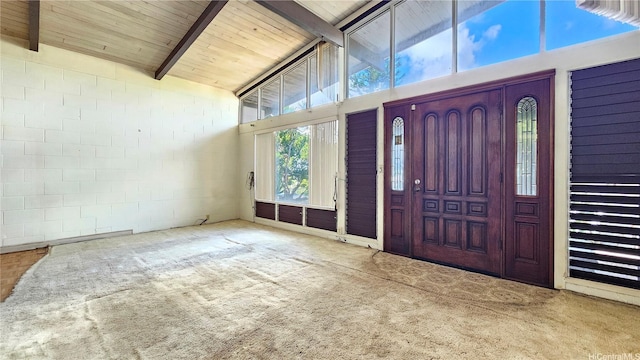 carpeted entryway with concrete block wall, wood ceiling, beam ceiling, and high vaulted ceiling