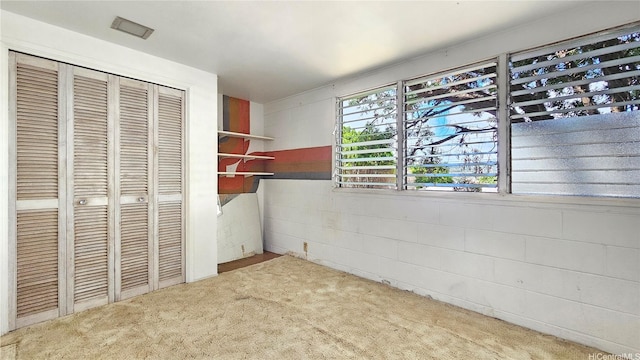 unfurnished bedroom with a closet and carpet flooring