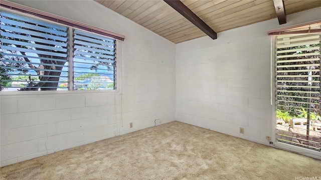 carpeted empty room featuring concrete block wall, wooden ceiling, and vaulted ceiling with beams