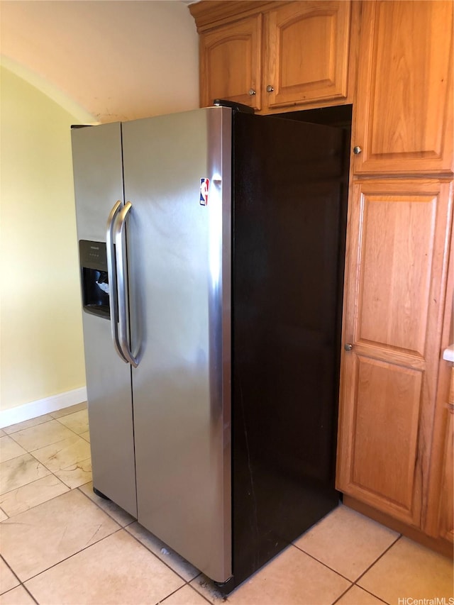 kitchen featuring stainless steel fridge and baseboards