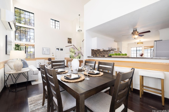 91-1046 Apaa St, Ewa Beach, HI 96706 - dining space featuring wood-type flooring, ceiling fan, a wall mounted AC, and a high ceiling