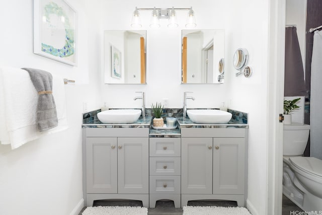91-1046 Apaa St, Ewa Beach, HI 96706 - bathroom featuring a sink, baseboards, toilet, and double vanity