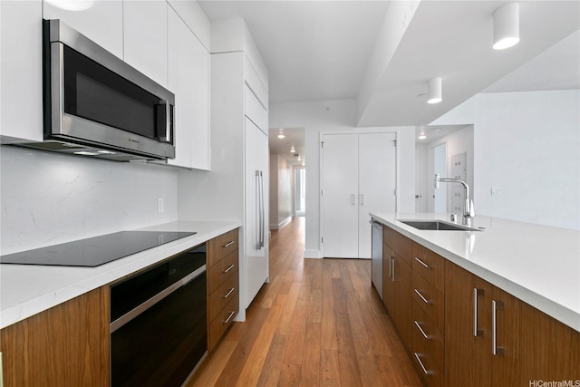 629 Keeaumoku St Unit 3401, Honolulu, HI 96814 - kitchen featuring appliances with stainless steel finishes, a sink, light countertops, white cabinetry, and modern cabinets