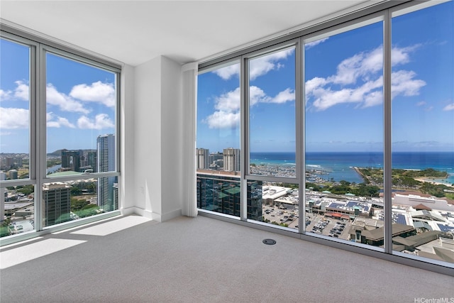 629 Keeaumoku St Unit 3401, Honolulu, HI 96814 - spare room featuring a view of city, a water view, carpet flooring, and expansive windows