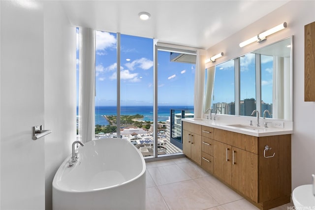 629 Keeaumoku St Unit 3401, Honolulu, HI 96814 - bathroom featuring double vanity, a sink, floor to ceiling windows, and a freestanding bath