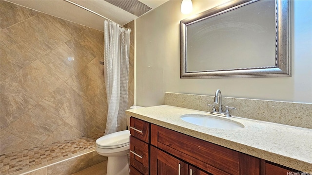 bathroom featuring a stall shower, vanity, and toilet