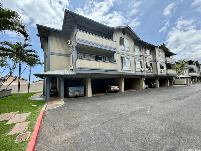 91-291 Hanapouli Cir Unit 4G, Ewa Beach, HI 96706 - view of building exterior with covered parking and fence