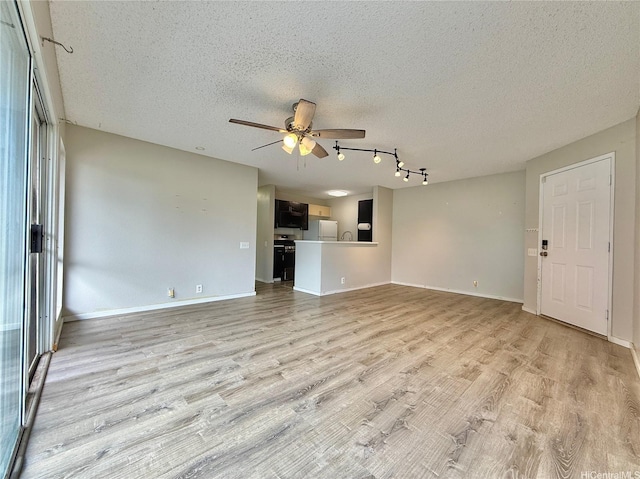 91-291 Hanapouli Cir Unit 4G, Ewa Beach, HI 96706 - unfurnished living room featuring a ceiling fan, light wood finished floors, and a textured ceiling