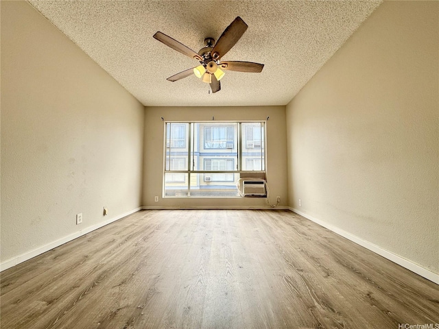 91-291 Hanapouli Cir Unit 4G, Ewa Beach, HI 96706 - unfurnished room featuring a textured ceiling, baseboards, a ceiling fan, and wood finished floors