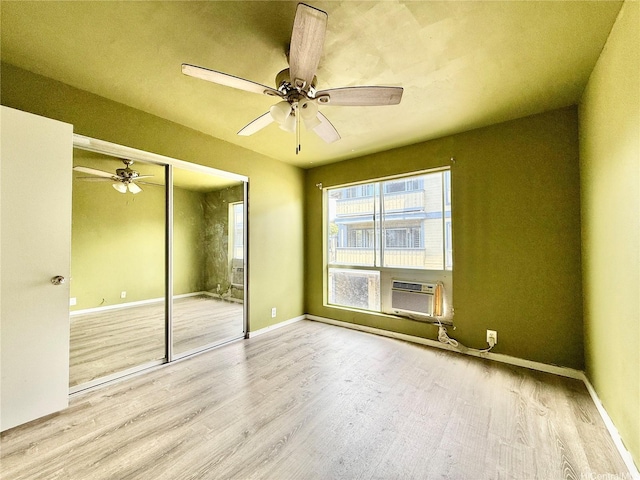 91-291 Hanapouli Cir Unit 4G, Ewa Beach, HI 96706 - unfurnished bedroom with baseboards, cooling unit, a closet, and wood finished floors