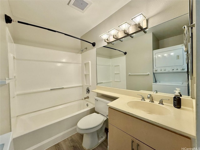 91-291 Hanapouli Cir Unit 4G, Ewa Beach, HI 96706 - full bathroom featuring stacked washer and dryer, toilet, wood finished floors,  shower combination, and visible vents