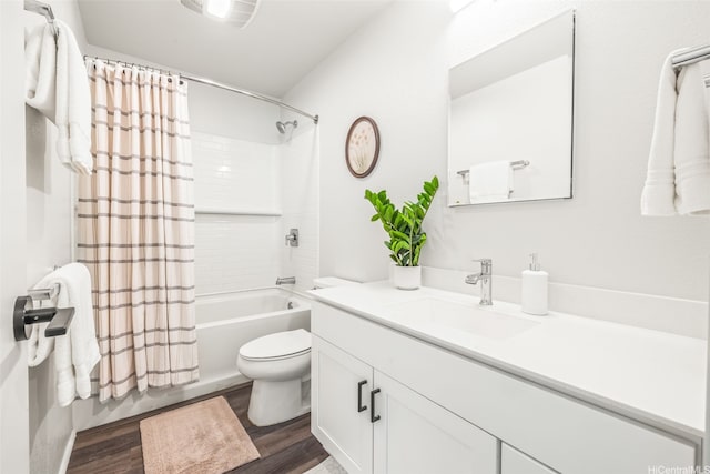 bathroom featuring toilet, shower / tub combo with curtain, wood finished floors, and vanity