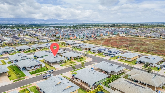 bird's eye view with a water and mountain view and a residential view