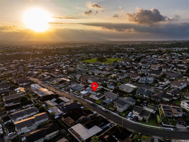 aerial view at dusk featuring a residential view