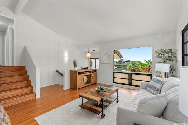living area featuring wood finished floors and vaulted ceiling