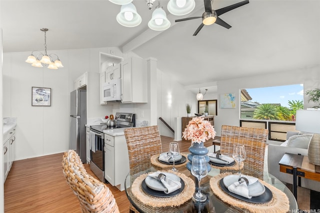 dining space featuring vaulted ceiling with beams, ceiling fan with notable chandelier, and light wood-style flooring