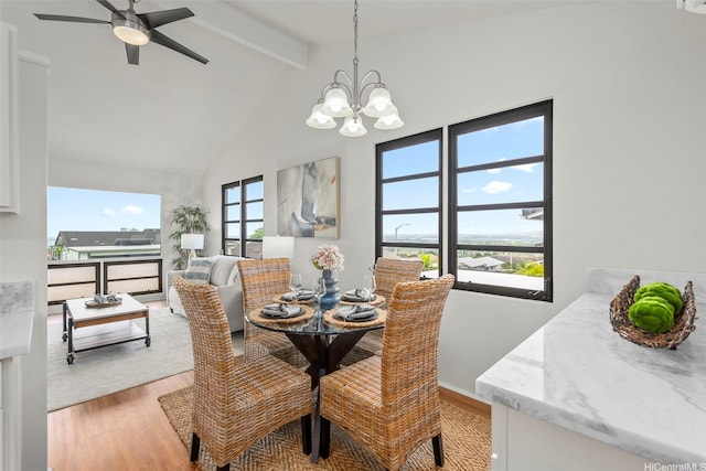 dining space with light wood-type flooring, high vaulted ceiling, baseboards, beamed ceiling, and ceiling fan with notable chandelier