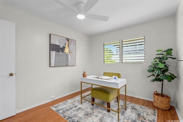 home office with baseboards, a ceiling fan, and wood finished floors