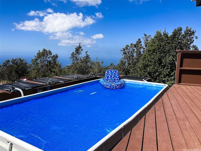 view of swimming pool featuring a deck
