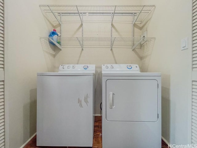 laundry room featuring baseboards, laundry area, and separate washer and dryer