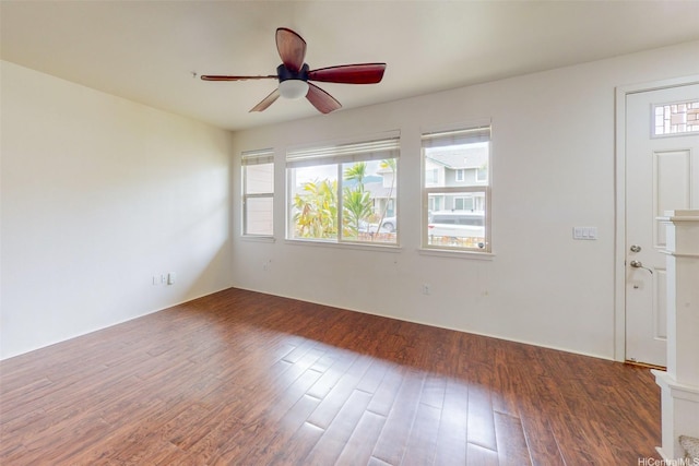 spare room with wood finished floors and a ceiling fan