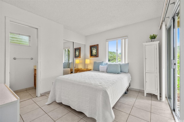 103 Kahako St Unit A, Kailua, HI 96734 - bedroom with light tile patterned floors, a textured ceiling, and a closet