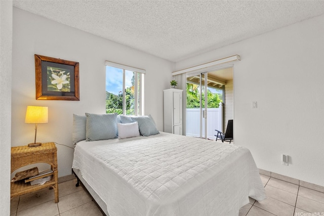 103 Kahako St Unit A, Kailua, HI 96734 - bedroom featuring access to outside, light tile patterned flooring, a textured ceiling, and baseboards