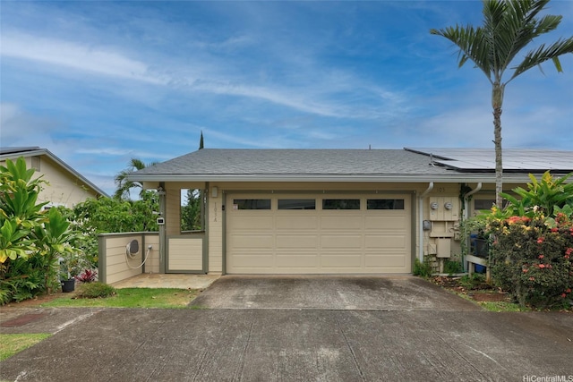 103 Kahako St Unit A, Kailua, HI 96734 - garage featuring driveway and roof mounted solar panels